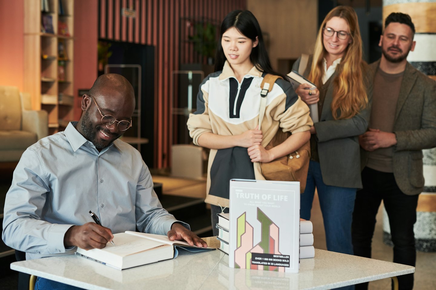 Author signs a copy of Truth of Life for waiting fans.